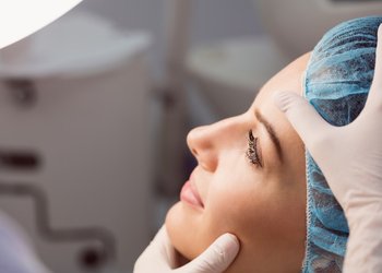 doctor-examining-womans-face-cosmetic-treatment